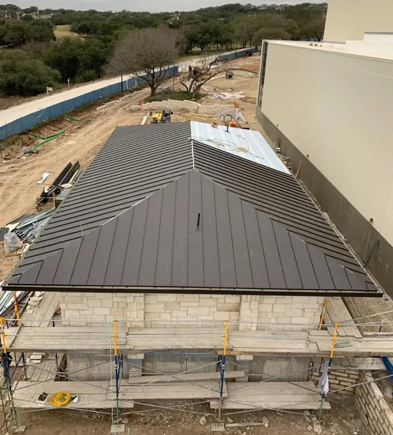 Metal roof new construction with scaffolding in Hollins